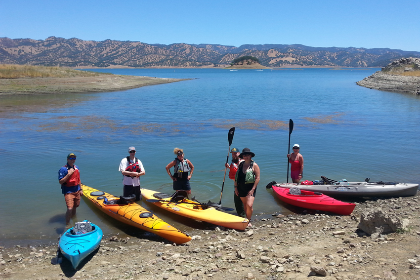 Visitors pose in the water ready to start kayaking.