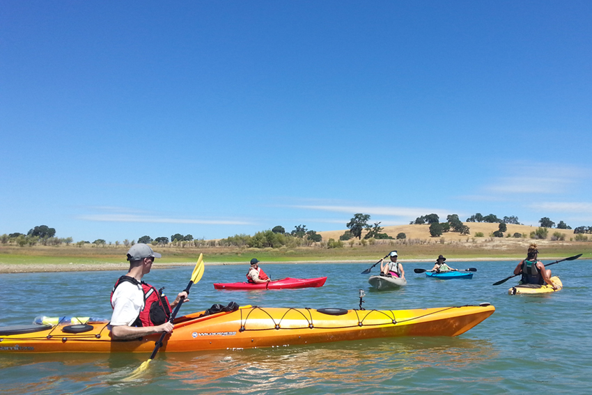 Group of 5 kayakers on the water at Lake Berryessa.