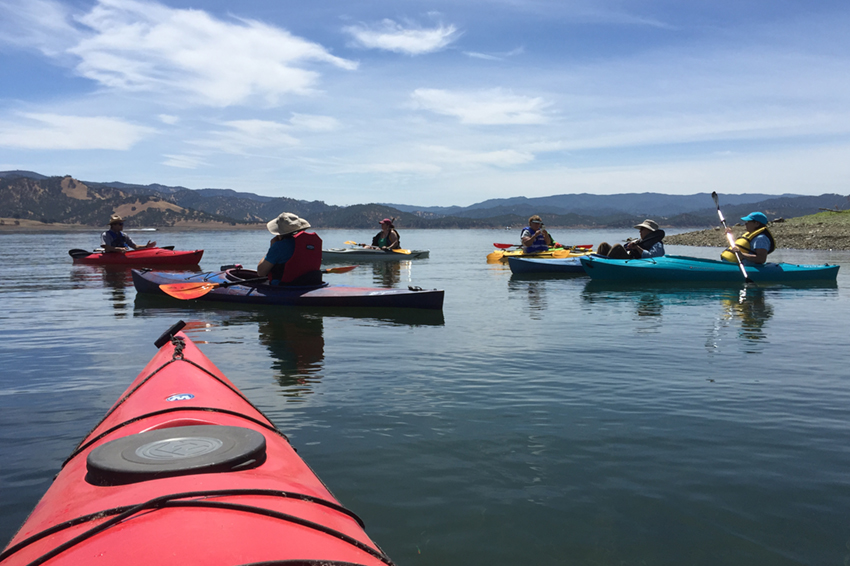 Kayakers on the water, as viewed from someone on a kayak close to them