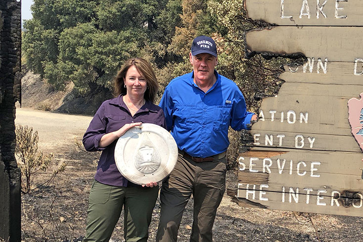 Reclamation Commissioner Brenda Burman holds a fire-salvaged Reclamation seal, here with Interior Secretary Ryan Zinke, at Whiskeytown Lake on Aug. 12, 2018. – Bureau of Land Management courtesy photo