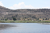 Lost River with sprinklers irrigating Klamath Project farms and dry hills in the background.