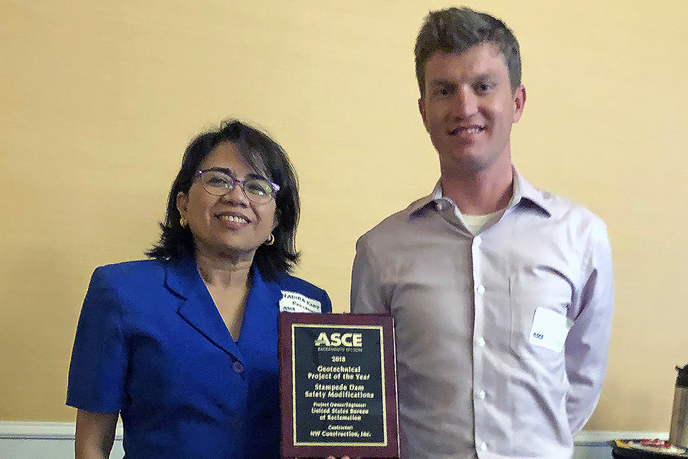 Nadira Kabir and Kyle Hughes pose with ASCE award