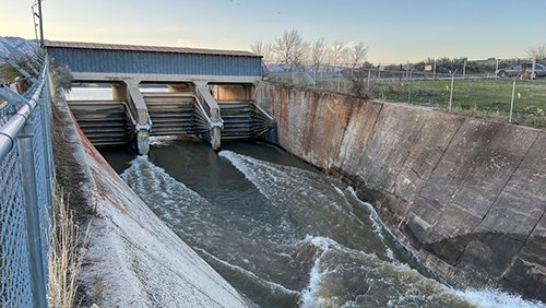 Water exiting Hyrum Reservoir through the radial arm gates and through the spillway.