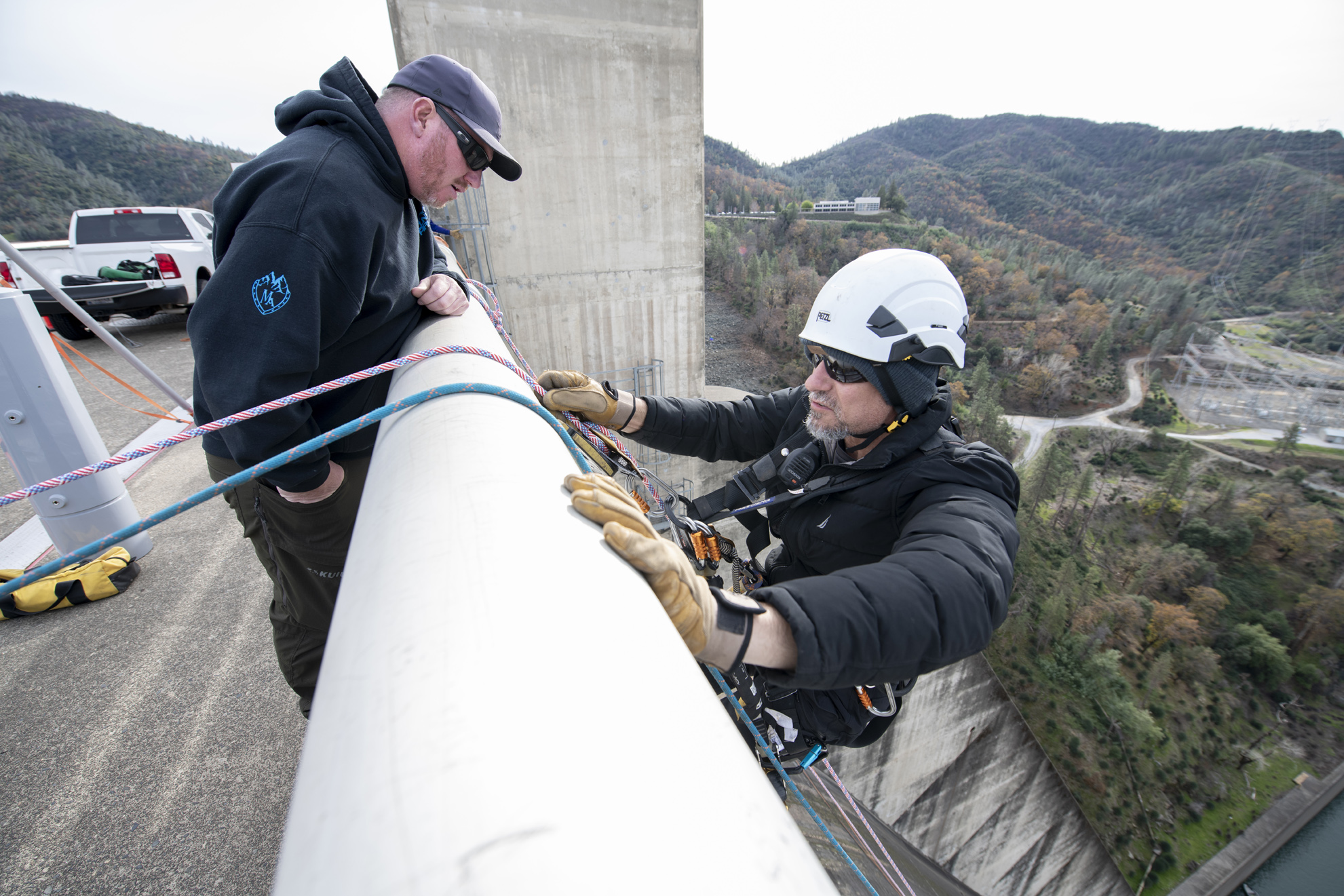 Left, Montegomery Brewer talks with James Hudleston before heading down the face of Shasta Dam.
