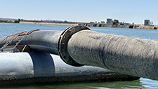 A large pipe floating on a lake.