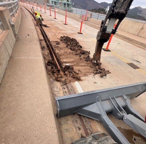 A Ripper attachment is used to remove the tar around the original rail.