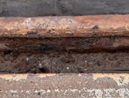 The original carbon-steel rail, bolts, and joint bar severely damaged by the corrosive effects of salt used to de-ice the road over many winters.