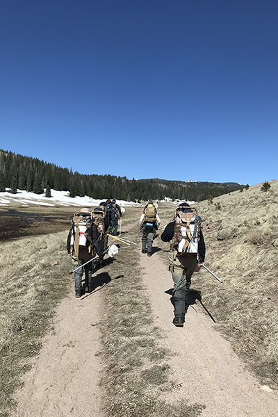 People hiking on a mountain trail.