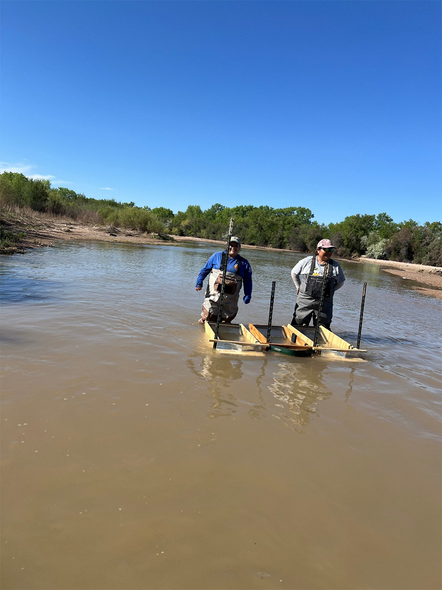 Reclamation intern Lourdes Padilla (left) and Reclamation biologist Shamarie Nez (right) waiting patiently while the collection boxes do their job.