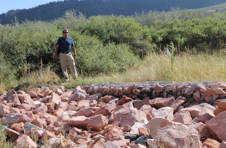 Patrick McCusker, Natural Resource Specialist from ECAO, checks the sediment dam in Soldier Canyon a week before Deputy Secretary Mike Connor's visit.