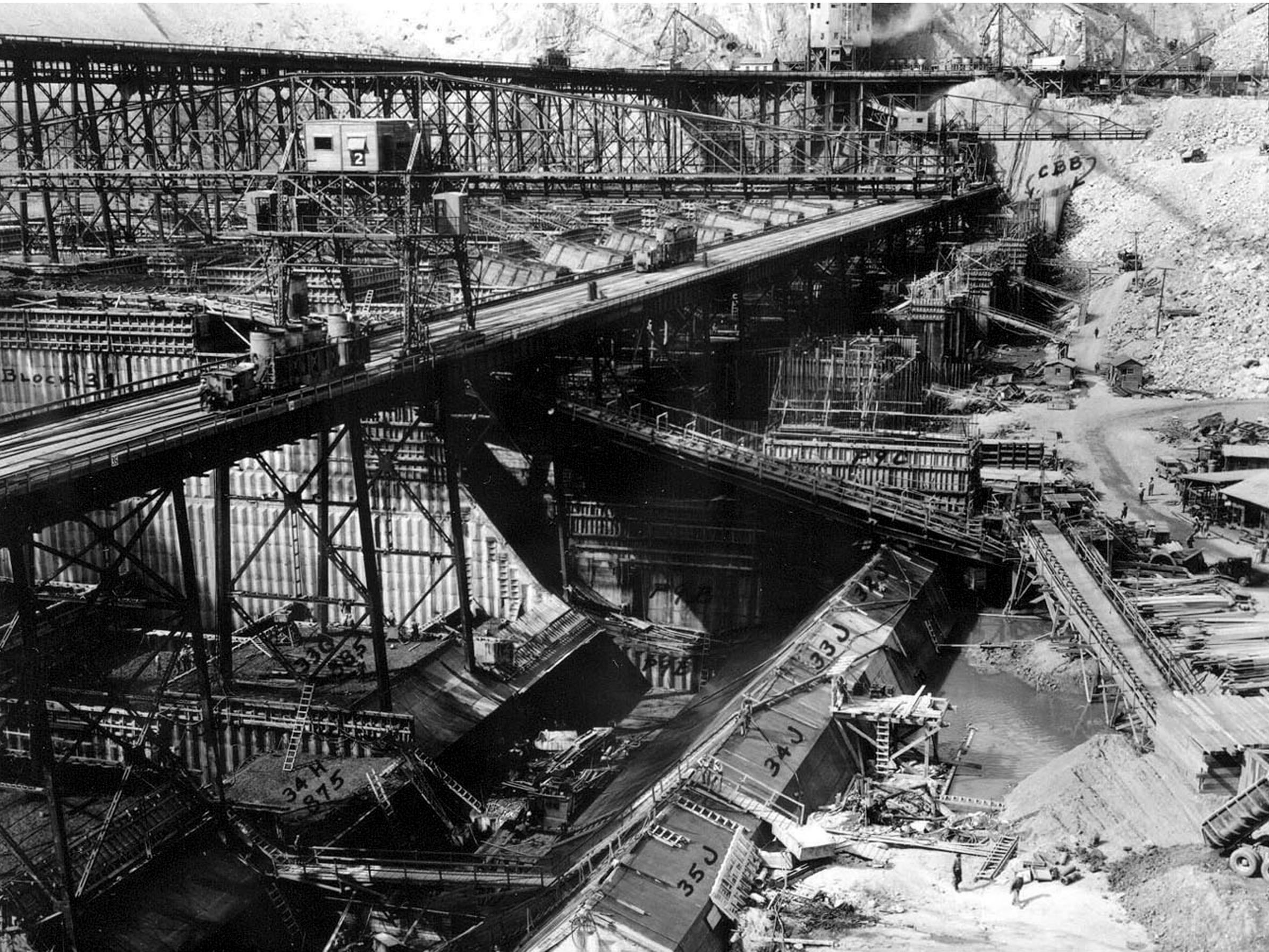 Photo taken August 28, 1936. West side mix plant and high and low crane trestles at Grand Coulee Dam.
