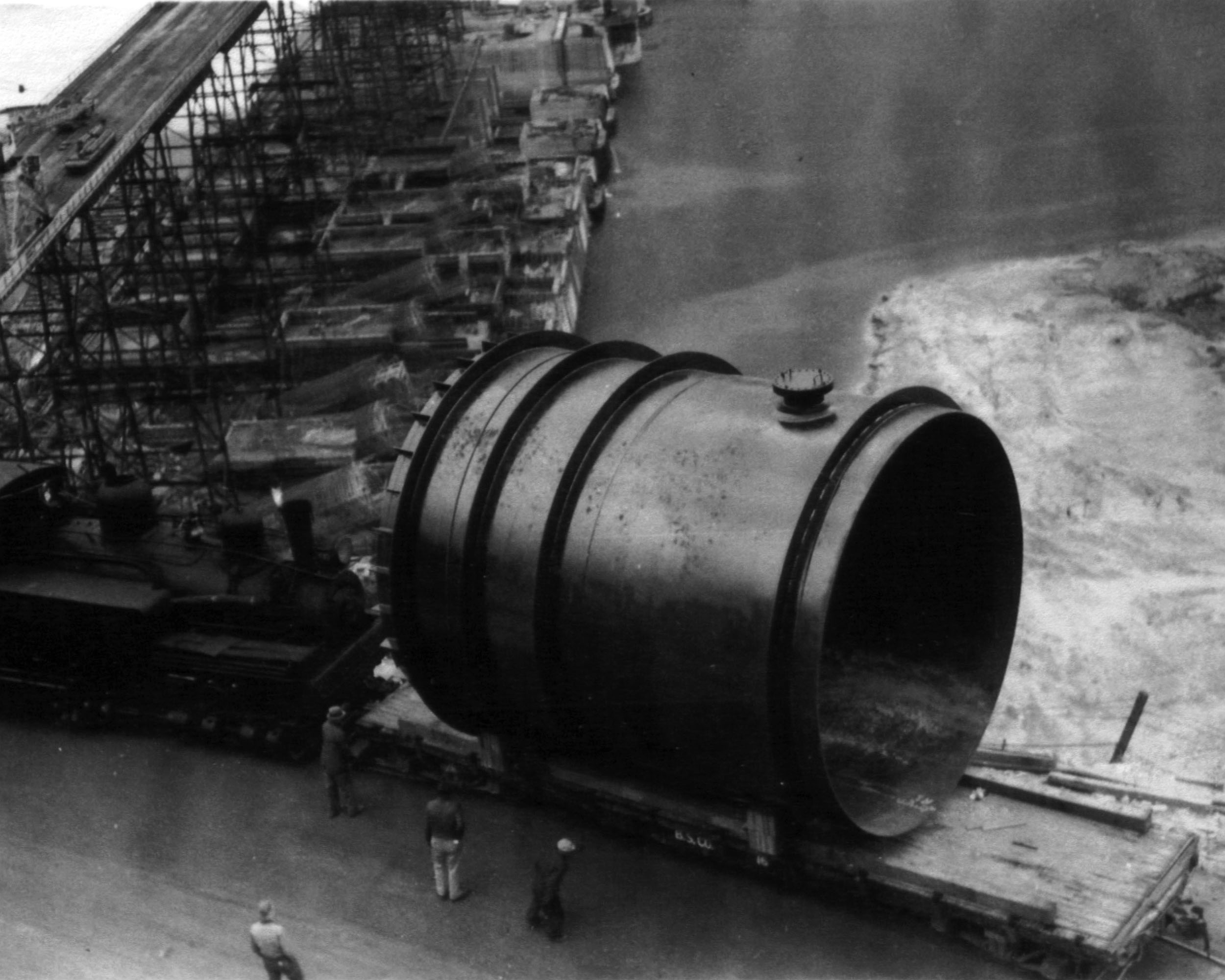 Photo taken October 12, 1938. An 18 ft. diameter penstock section brought by train from the fabricating plant in Electric City to Grand Coulee Dam.