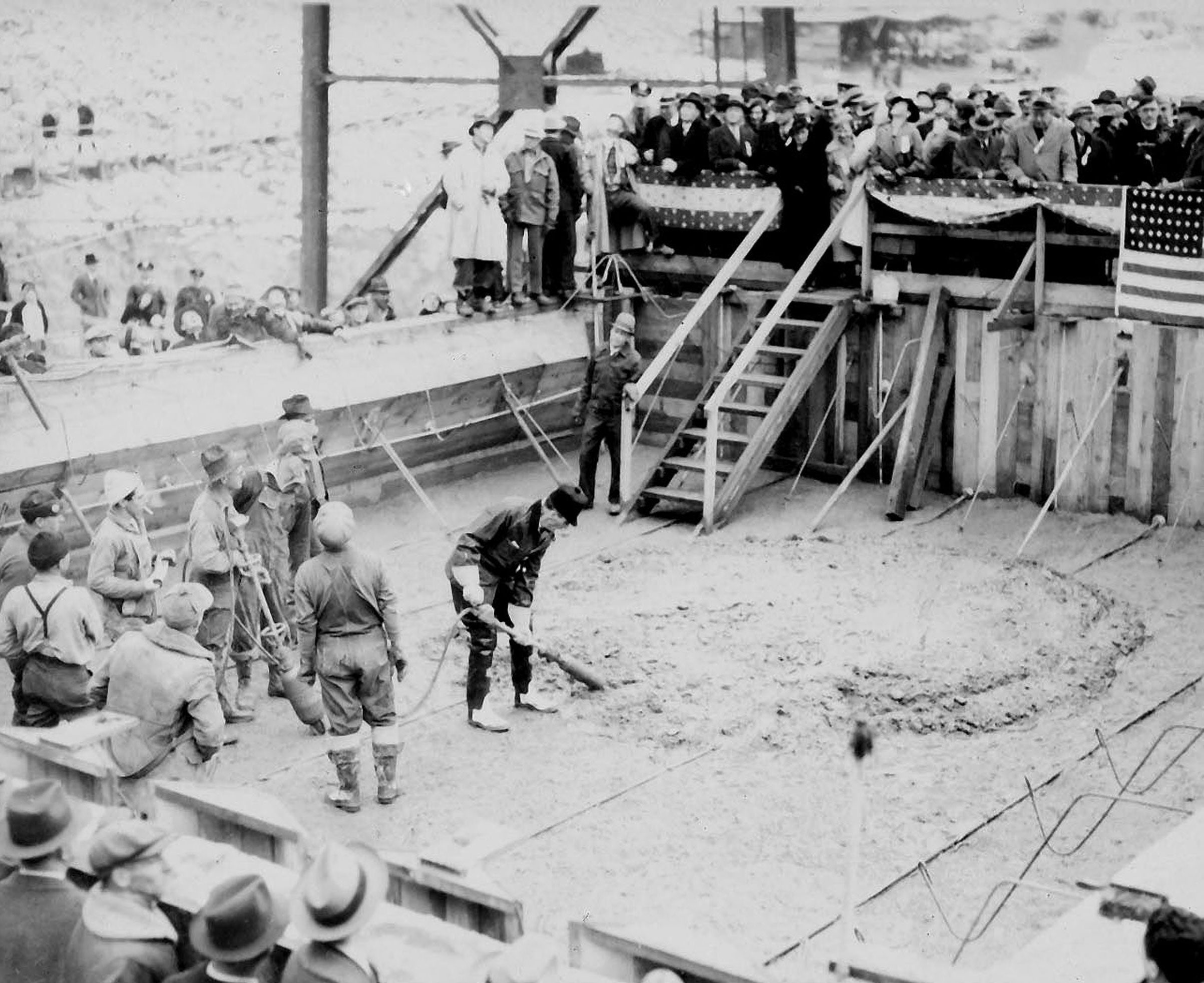 December 6, 1935. Governor Clarence C. Martin vibrating first official concrete pour at Grand Coulee Dam.