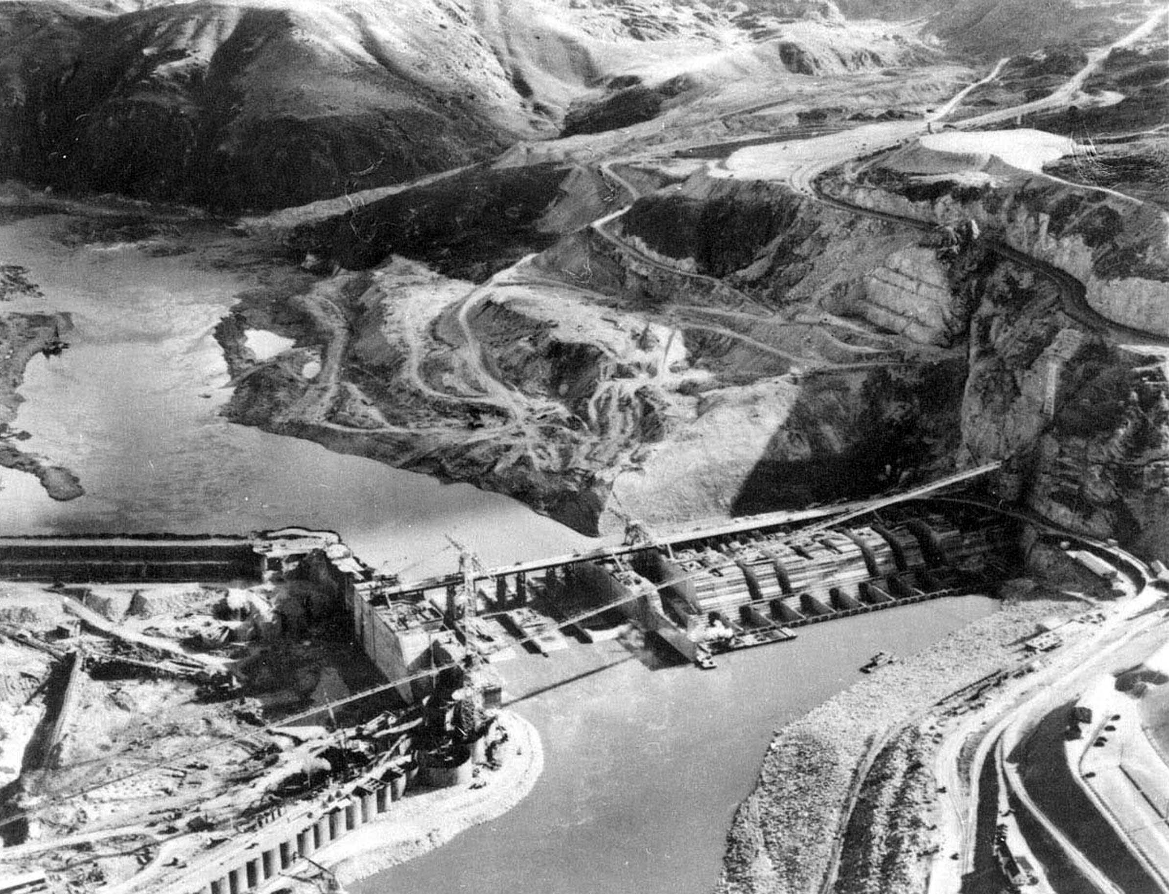 Circa 1936. East side cofferdam on left with diversion channel center and Grand Coulee Dam foundation taking shape center.