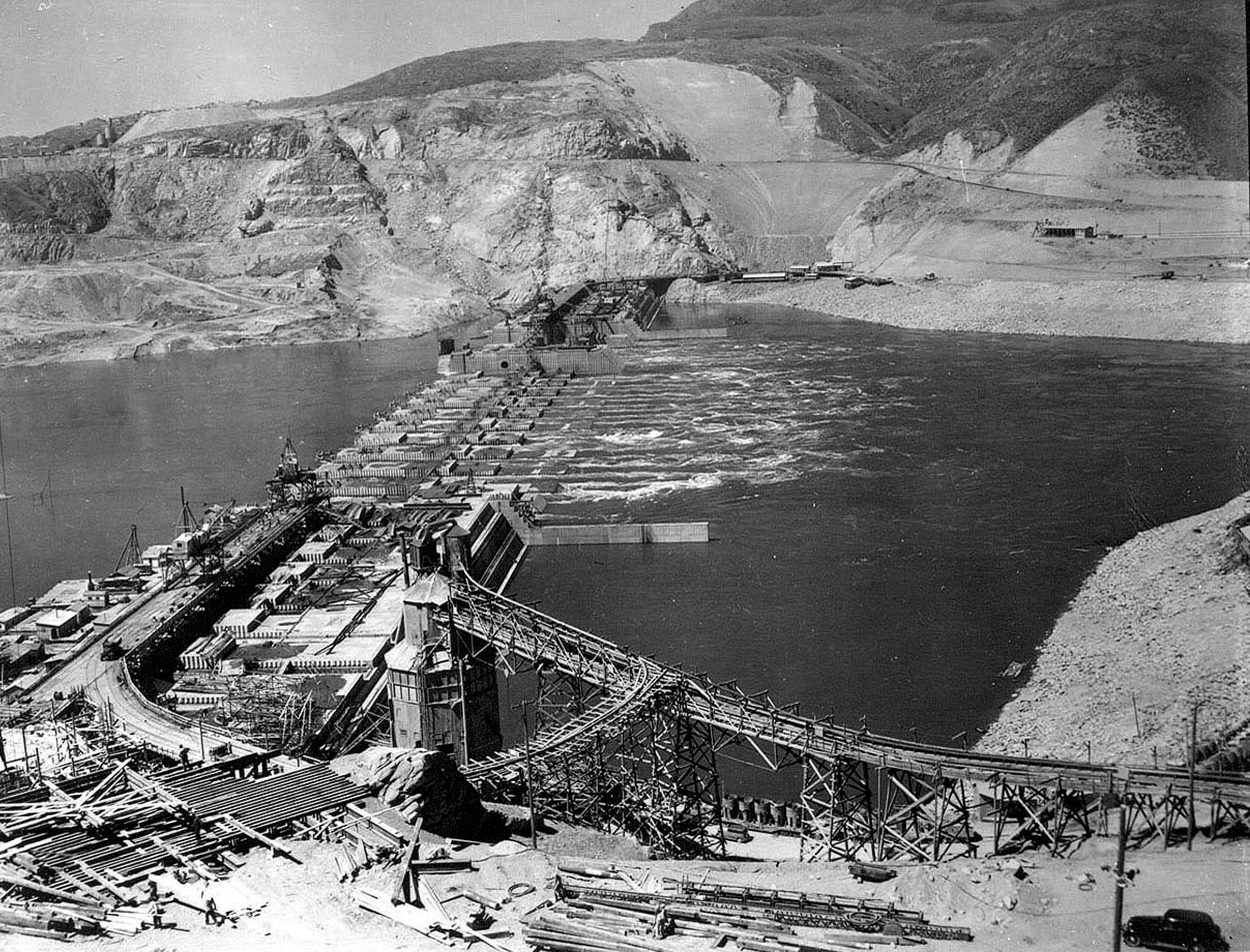 Circa 1936. East mix plant in foreground and overall view of Grand Coulee Dam project.