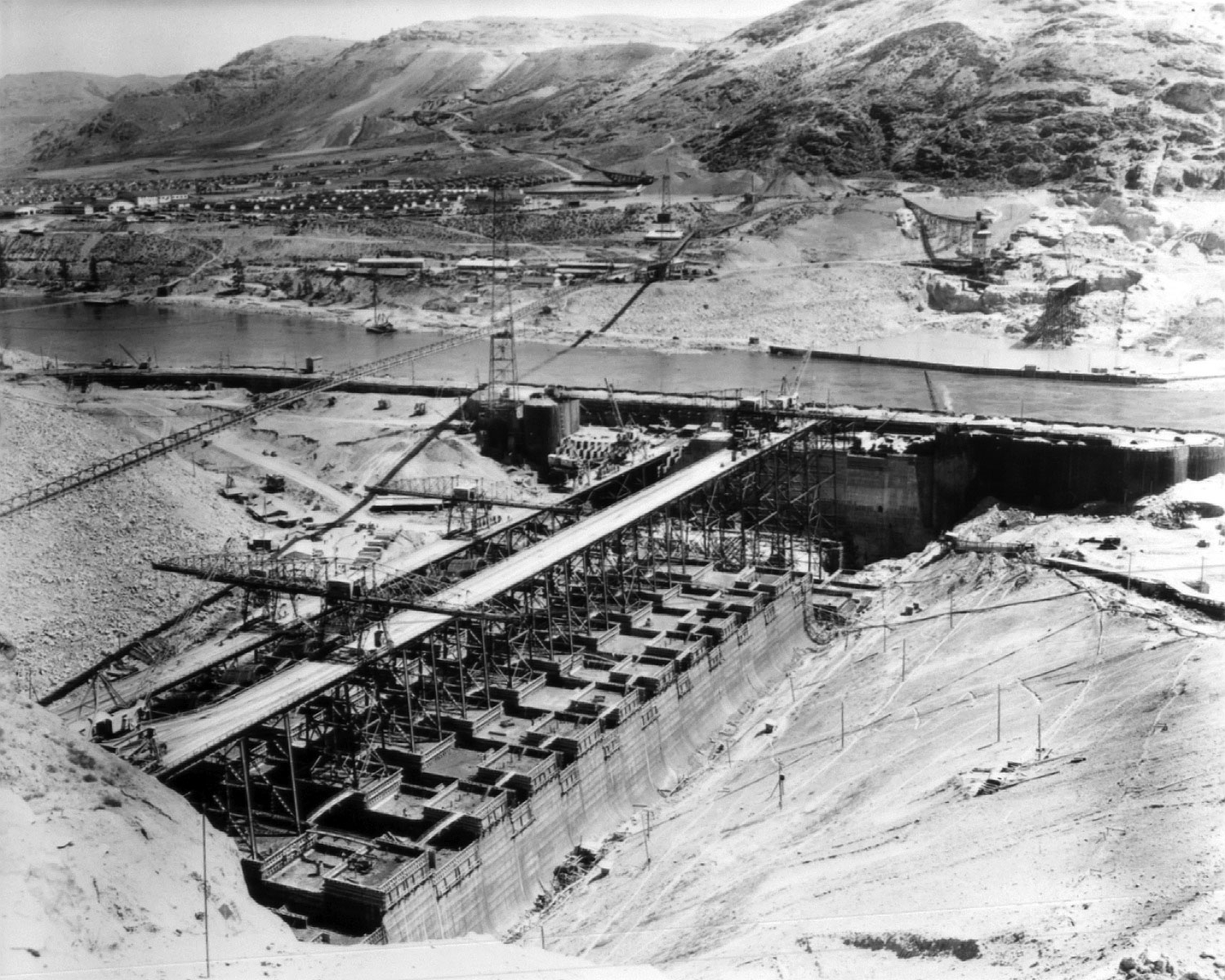 July 24, 1936. West side high and low crane trestles with cantilever cranes at Grand Coulee Dam.