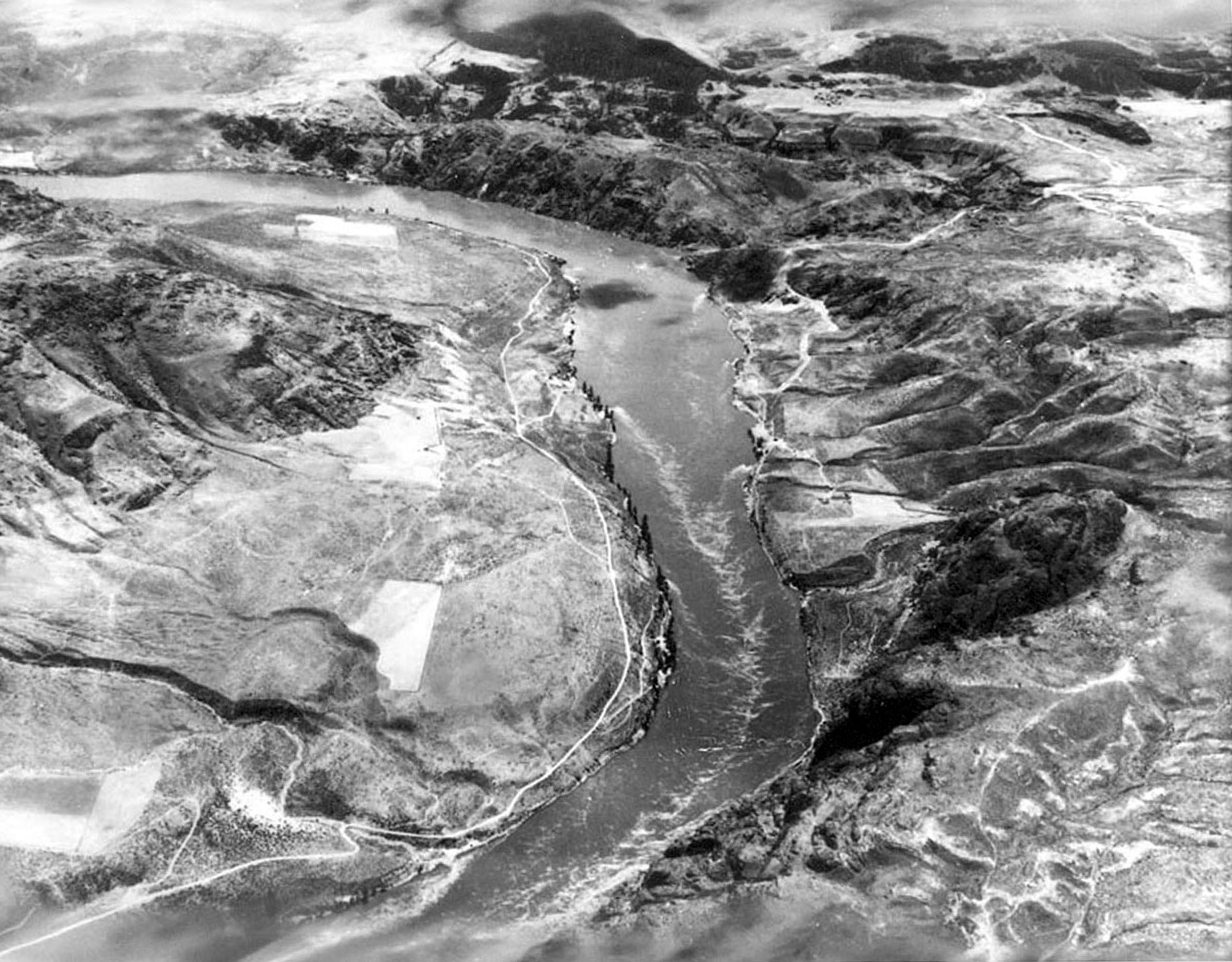 Photo taken Circa 1933. The Columbia River, showing the site for the Grand Coulee Dam.