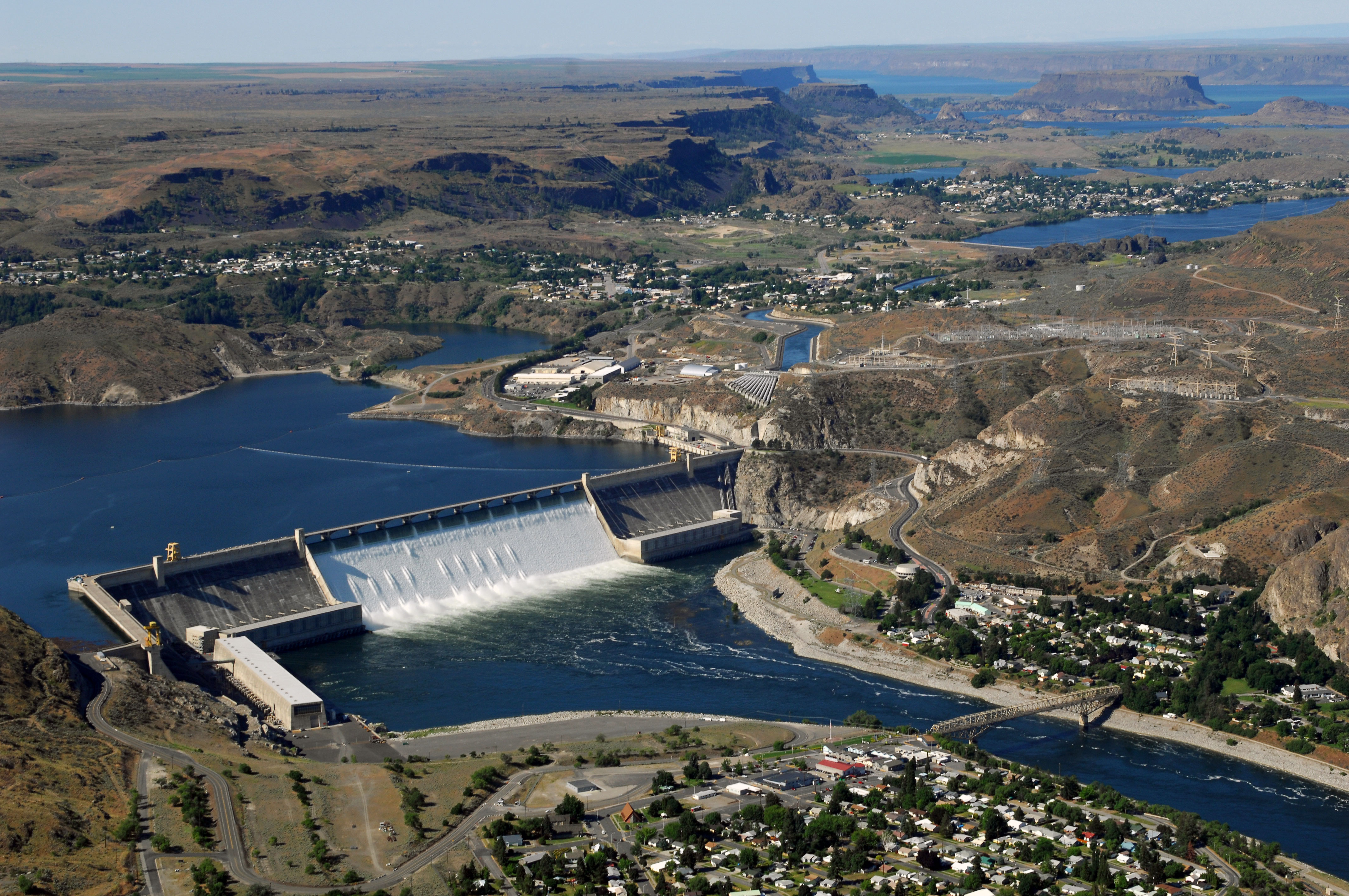 Aerial view of Grand Coulee Dam releasing downstream an unusually large and late spring time water flows of over 200,000 cfs. Broken out, it’s 33,800 cfs, over the spillway and 167,000 cfs through the hydropower generators