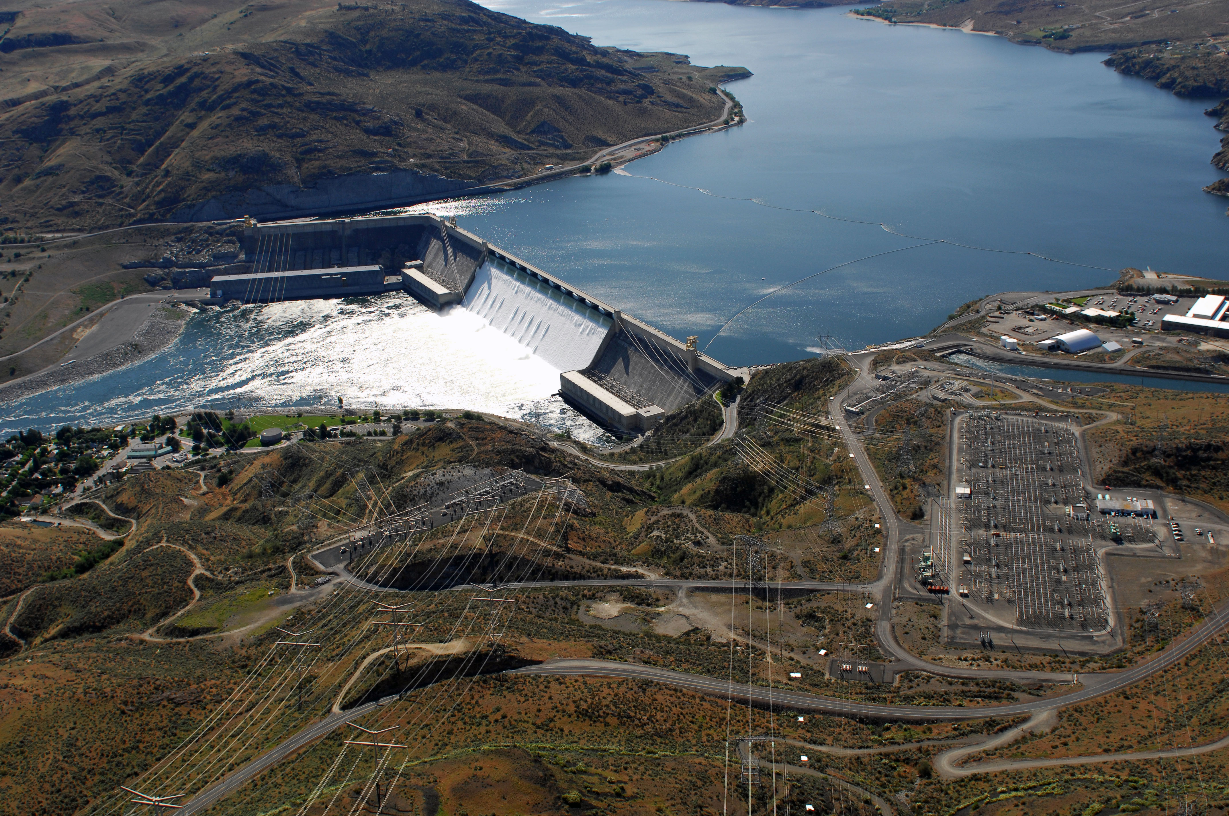 Aerial view of Grand Coulee Dam releasing downstream an unusually large and late spring time water flows of over 200,000 cfs. Broken out, it’s 33,800 cfs, over the spillway and 167,000 cfs through the hydropower generators