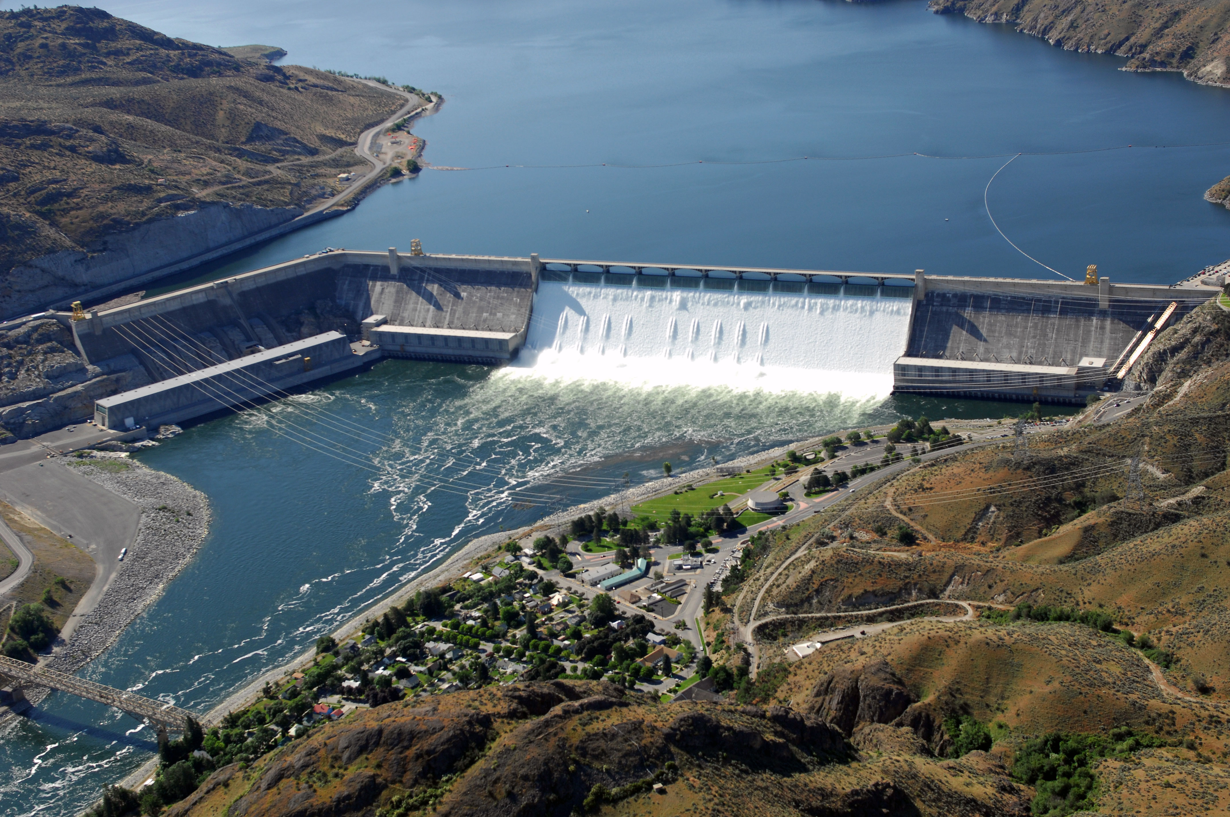 Aerial view of Grand Coulee Dam releasing downstream an unusually large and late spring time water flows of over 200,000 cfs. Broken out, it’s 33,800 cfs, over the spillway and 167,000 cfs through the hydropower generators