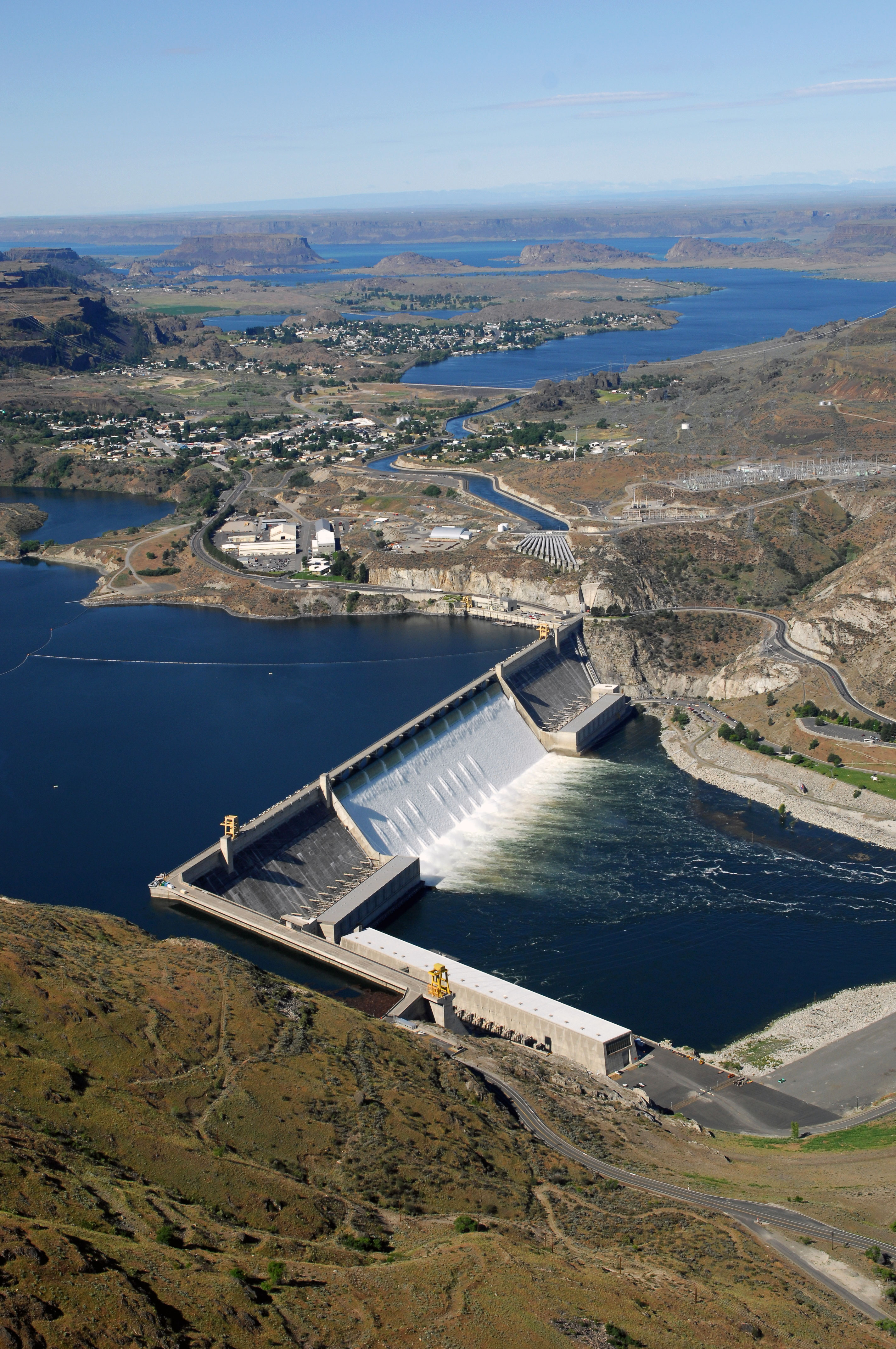 Aerial view of Grand Coulee Dam releasing downstream an unusually large and late spring time water flows of over 200,000 cfs. Broken out, it’s 33,800 cfs, over the spillway and 167,000 cfs through the hydropower generators