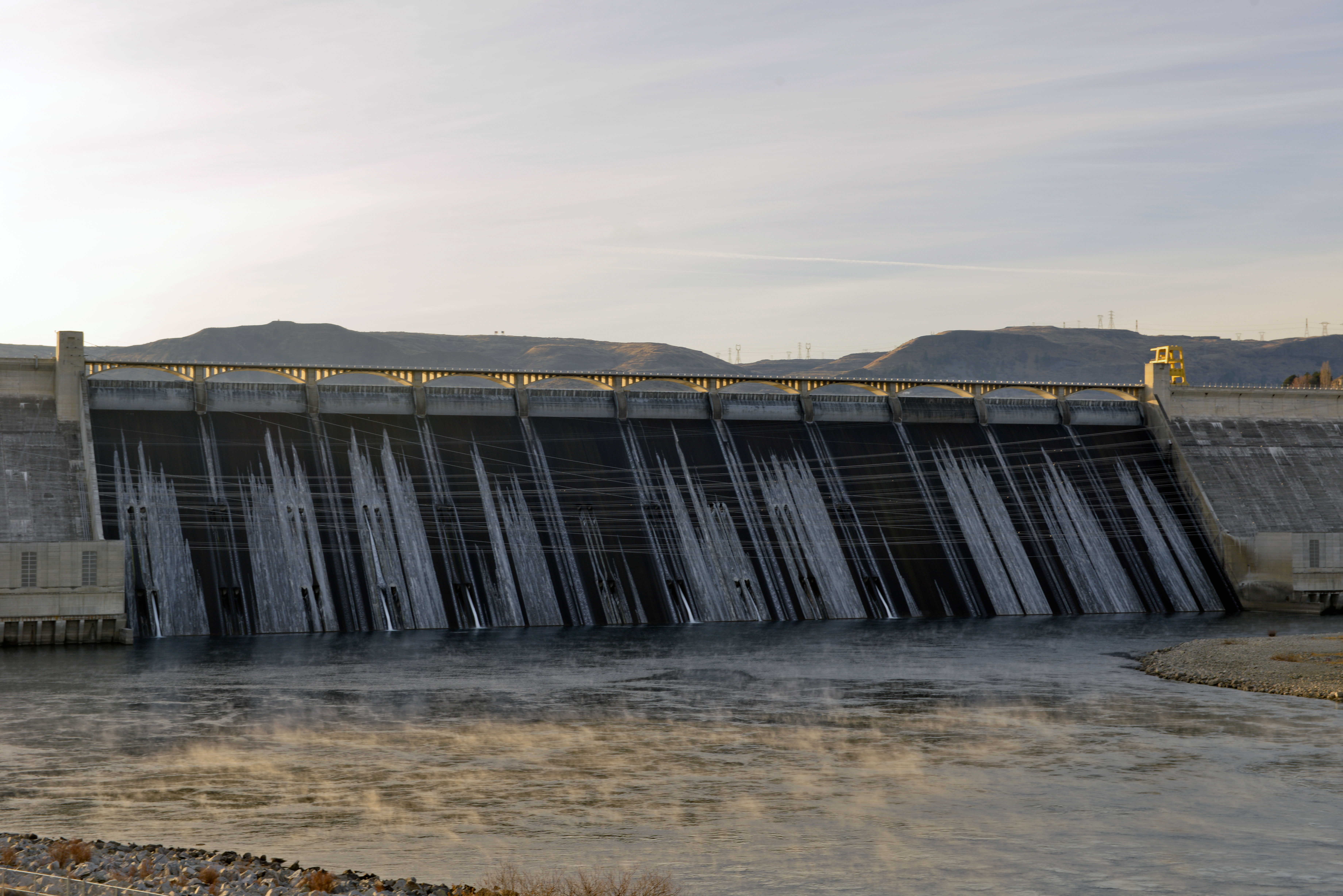 November 21, 2013. Grand Coulee Dam in the morning light. The cold November air causes water to freeze on the face of the dam and steam to rise from the water in the stilling basin.