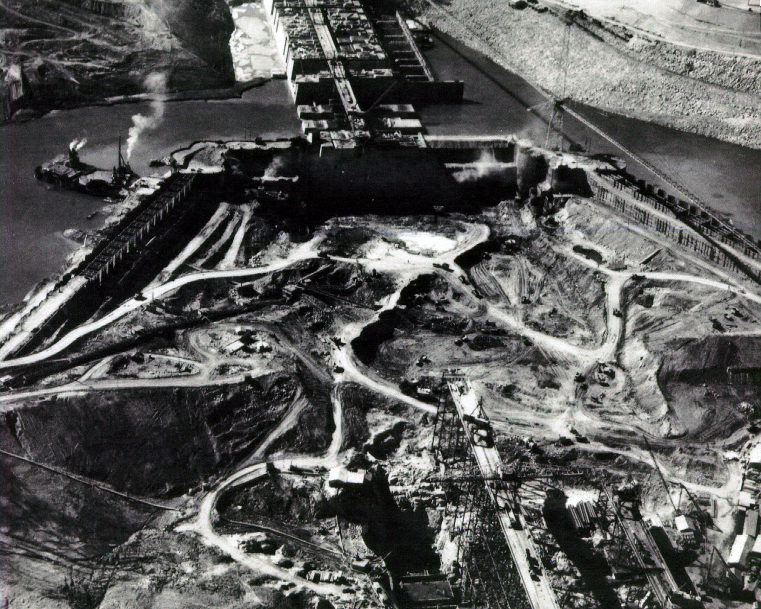 1936. Cofferdam. You can see how the cofferdam clears a portion of the riverbed for excavation.