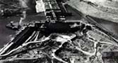 1936. Cofferdam. You can see how the cofferdam clears a portion of the riverbed for excavation.