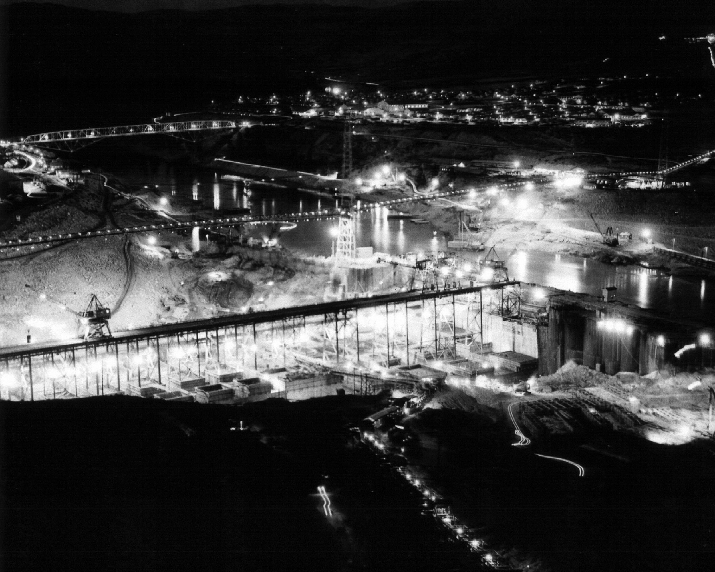 1936. Work to get the foundation prepared takes place around the clock.