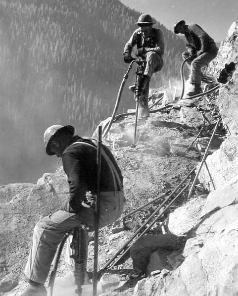 Jackhammer crews operating on Hungry Horse damsite abutment. September 27, 1948.