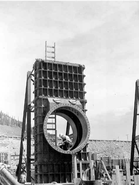 View showing the first of three ring follower gates being installed at Hungry Horse Dam to control flow of water through the 96 inch outlet tubes. October 2, 1950.