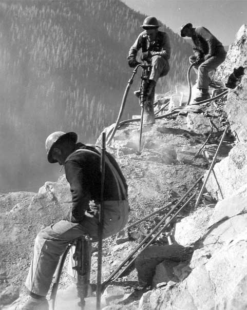 Jackhammer crews operating on Hungry Horse damsite abutment.