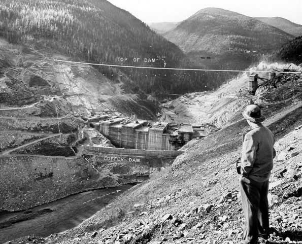Construction progress at Hungry Horse Dam, including markings indicating where the top of the dam should be.