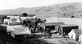 Government forces construction camp below the Boise River Diversion dam on south bank of the river, during construction of powerhouse