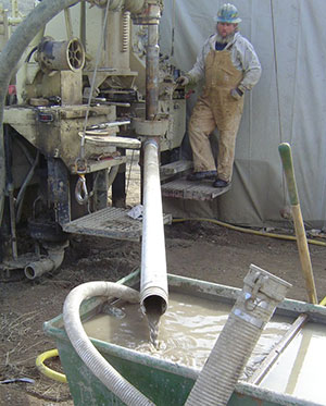 (Right) February 2004 Drilling operation, drill hole DH-04-1 at the alternate dam site.