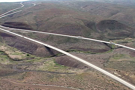 May 2007: Arial photo of east and westbound bridges over Lumuma Creek looking northeast. The upper end of the proposed Wymer Reservoir will extend upstream of the bridges a few miles at normal water surface elevation of 1730 feet.