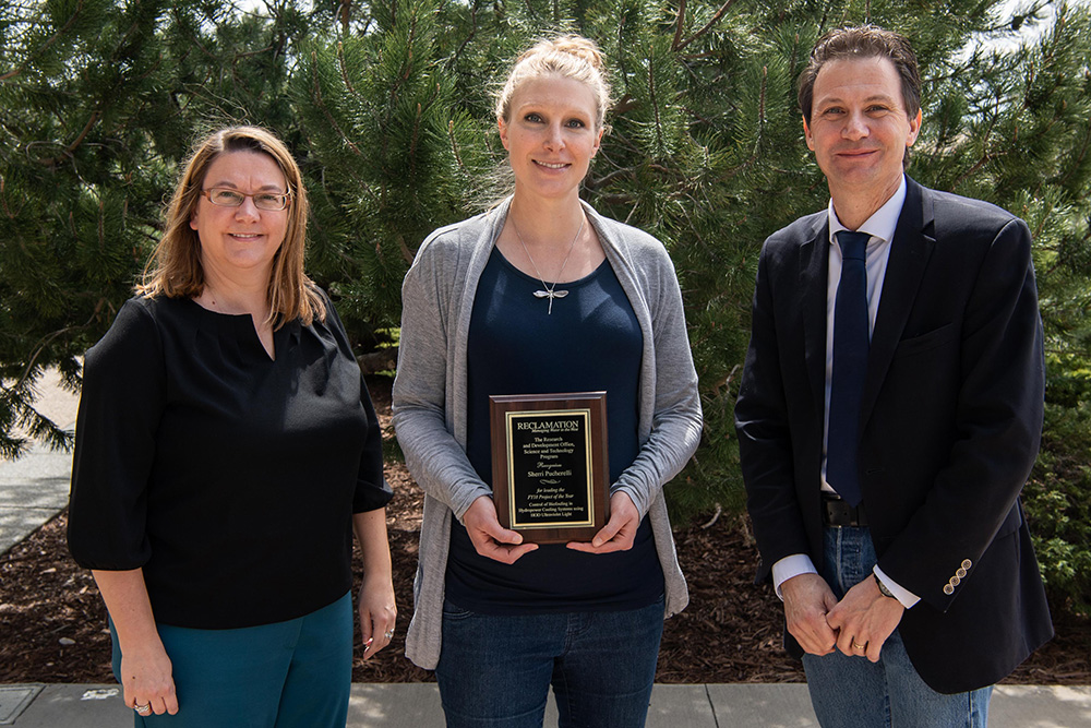 Sherri Pucherelli with Deputy Commissioner's Shelby Hagenauer and David Palumbo. Pucherelli lead the research team that studied UV light to control invasive mussel biofouling in hydropower cooling systems.
