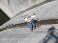 Photo showing man with his arms up at the side of Canyon Ferry Dam