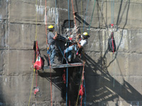 Men working on dam face