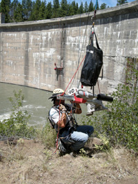 working on the side of the dam