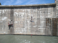 Long shot of men working on the dam face