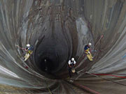 photo: Rope access team rappelling down Flaming Gorge Dam spillway tunnel