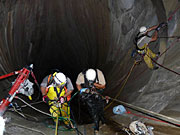 photo: Rope access team doing repairs inside Flaming Gorge Dam spillway tunnel 