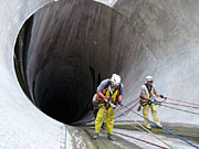 photo: Rope access team rappelling down Flaming Gorge Dam spillway tunnel