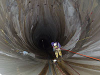 photo: Rope access team member rappelling down Flaming Gorge Dam spillway tunnel