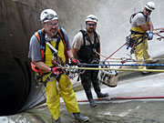 photo: Rope access team preparing to descend inside Flaming Gorge Dam spillway tunnel