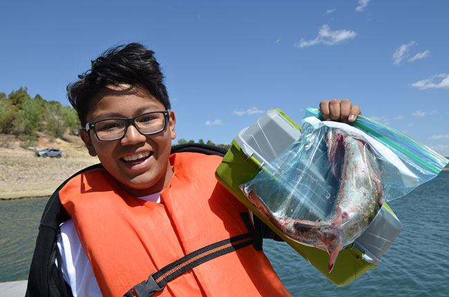 C.A.S.T. for Kids participate showing off his catch of the day