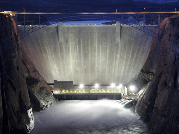 Night view of Glen Canyon Dam and all four jet tubes open releasing water during high-flow experiment - March 5, 2008