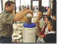 Photos of kids watching a demonstration at water festival