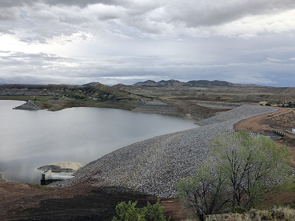 View of Steinaker Dam's outlet works intake from the right abutment showing the work done to flatten the embankment.